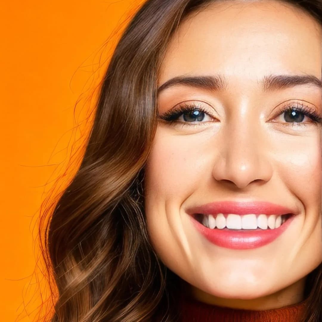 Sierra “Sisi” Moses smiling against a bright orange background